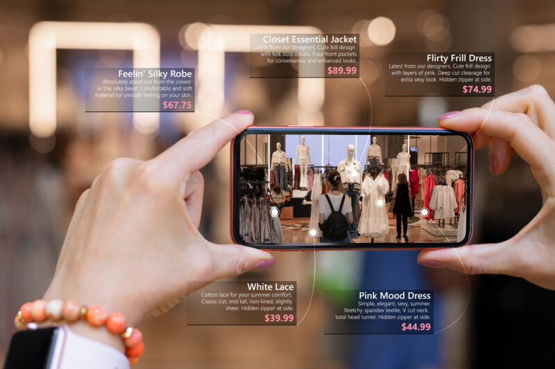 Augmented reality tech used by woman on her phone while shopping for new clothes in store